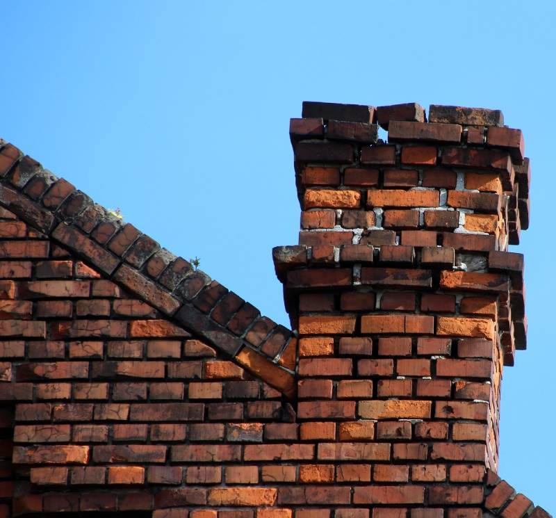 Signs Your Euless Home Needs a Chimney Inspection Damaged chimney on an Euless home showing cracks and missing mortar